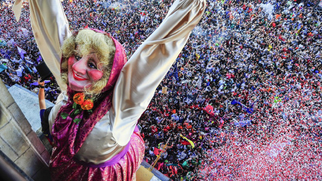 A plump figurine with her arms wide open in celebration