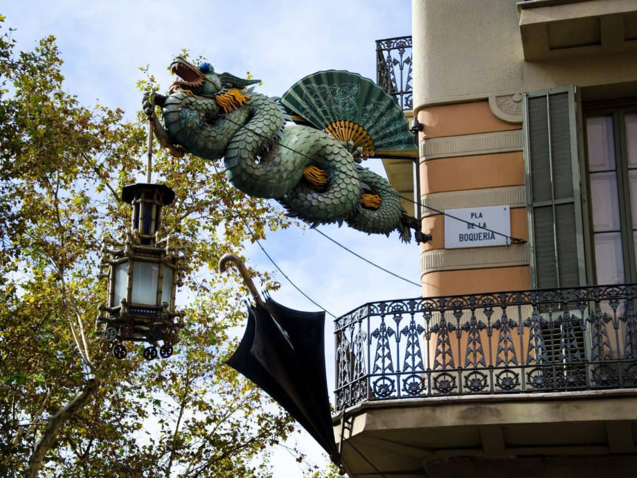 Iron Chinese dragon sculpture on a building in Barcelona.