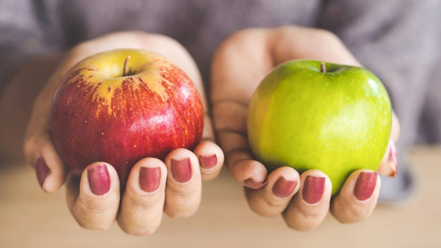 Hands holding apples