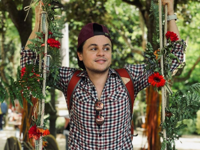 portrait of a young man with flowers and green background