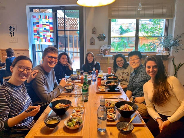 smiling people sharing food at a table