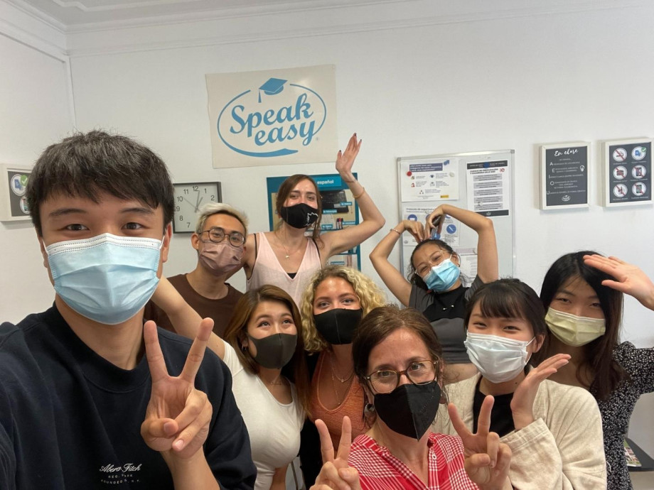 Students wearing masks in a classroom selfie.