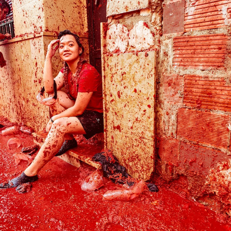 Girl sitting in doorway with tomato juice everywhere.