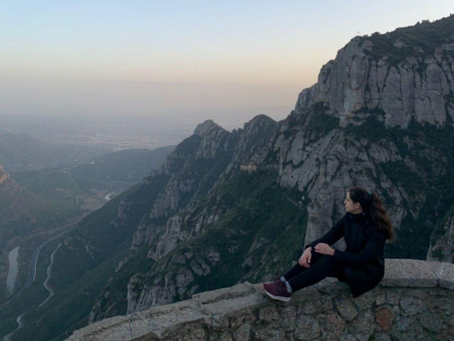 Girl sitting and taking in views of Montserrat mountain