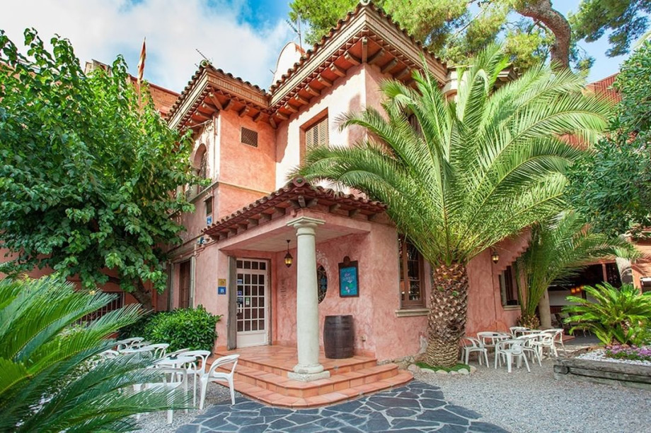 old style house in Barcelona with palm trees and beautiful terrace.
