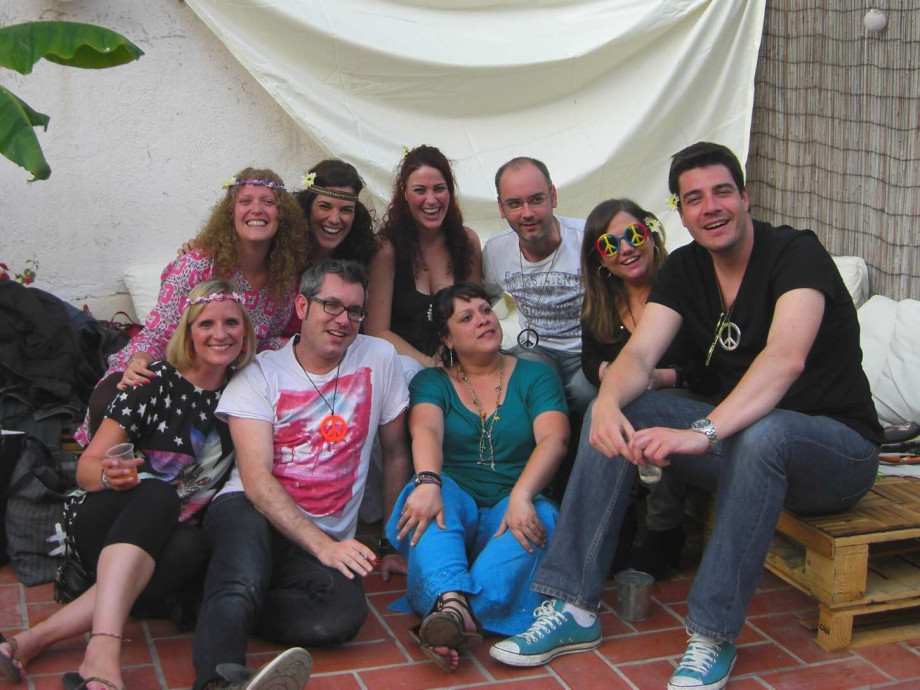 group of people smiling together on a rooftop terrace.