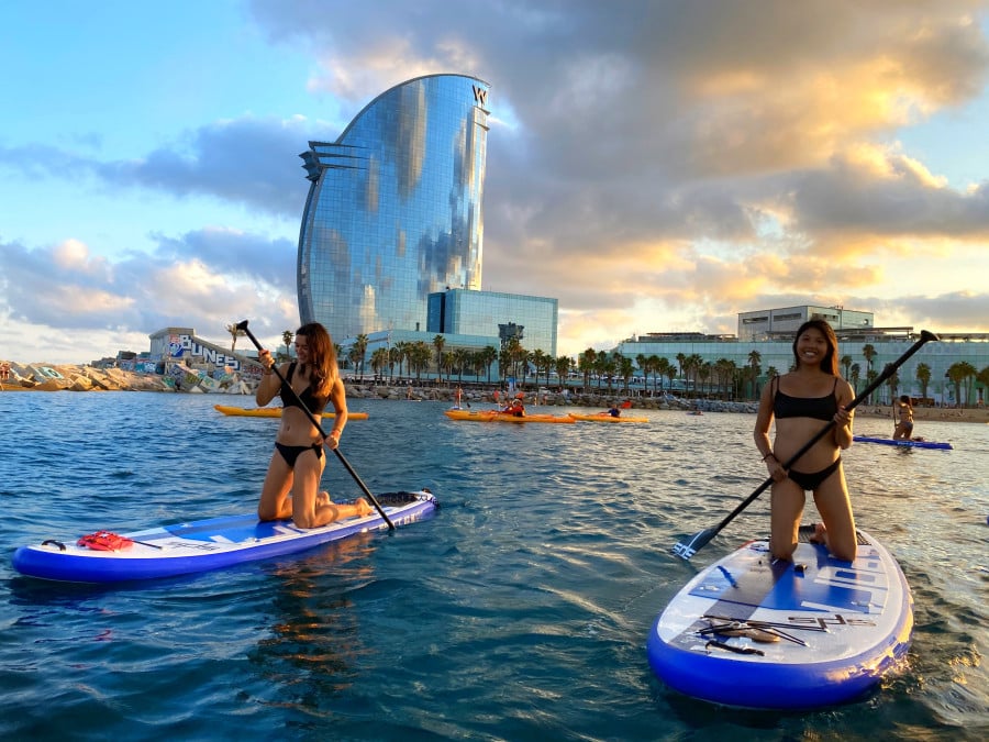 Speakeasy students smiling during a paddle-boarding activity